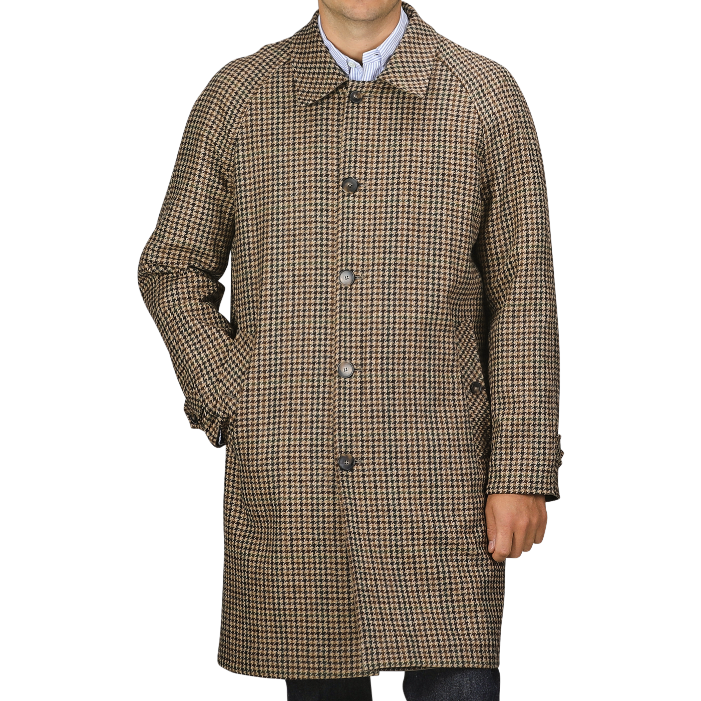 A man standing with one hand in his pocket, wearing a Beige Houndstooth Wool Tweed Reversible Coat from L'Impermeabile over a collared shirt. Image cropped at the knees against a plain gray background.