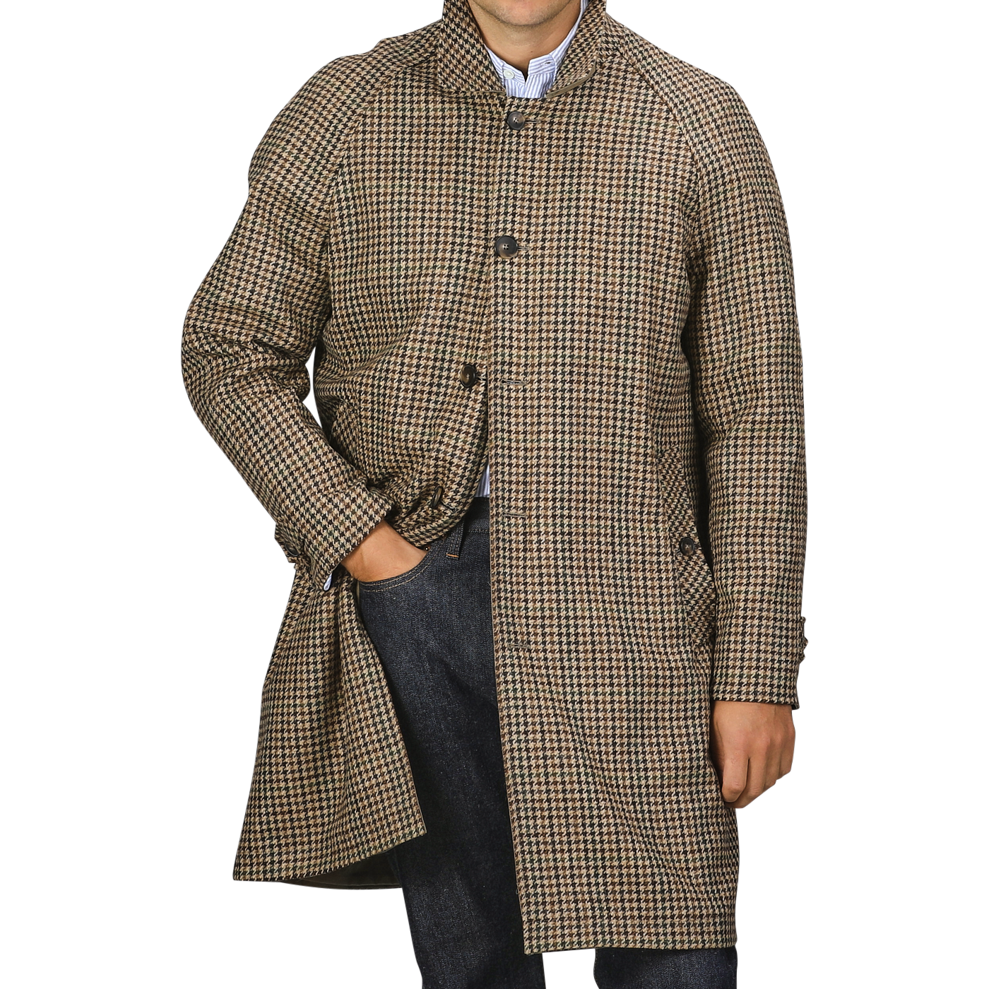 A person stands wearing a L'Impermeabile Beige Houndstooth Wool Tweed Reversible Coat with their right hand in their jeans pocket.