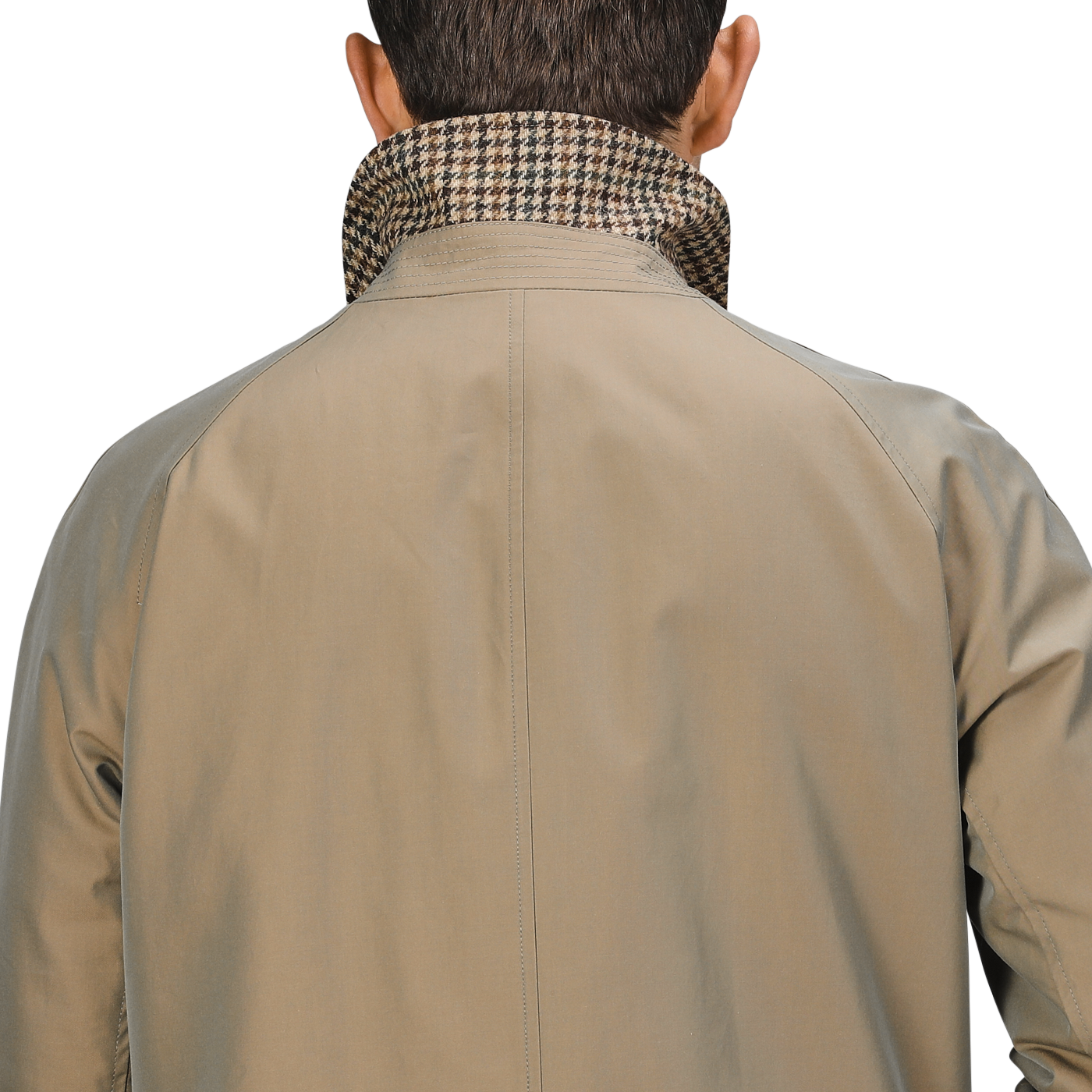 A person is shown from the back wearing the L'Impermeabile Beige Houndstooth Wool Tweed Reversible Coat with its houndstooth pattern collar turned up.