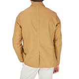 The back view of a man wearing a L'Impermeabile Camel Beige Waxed Linen College LL Jacket.