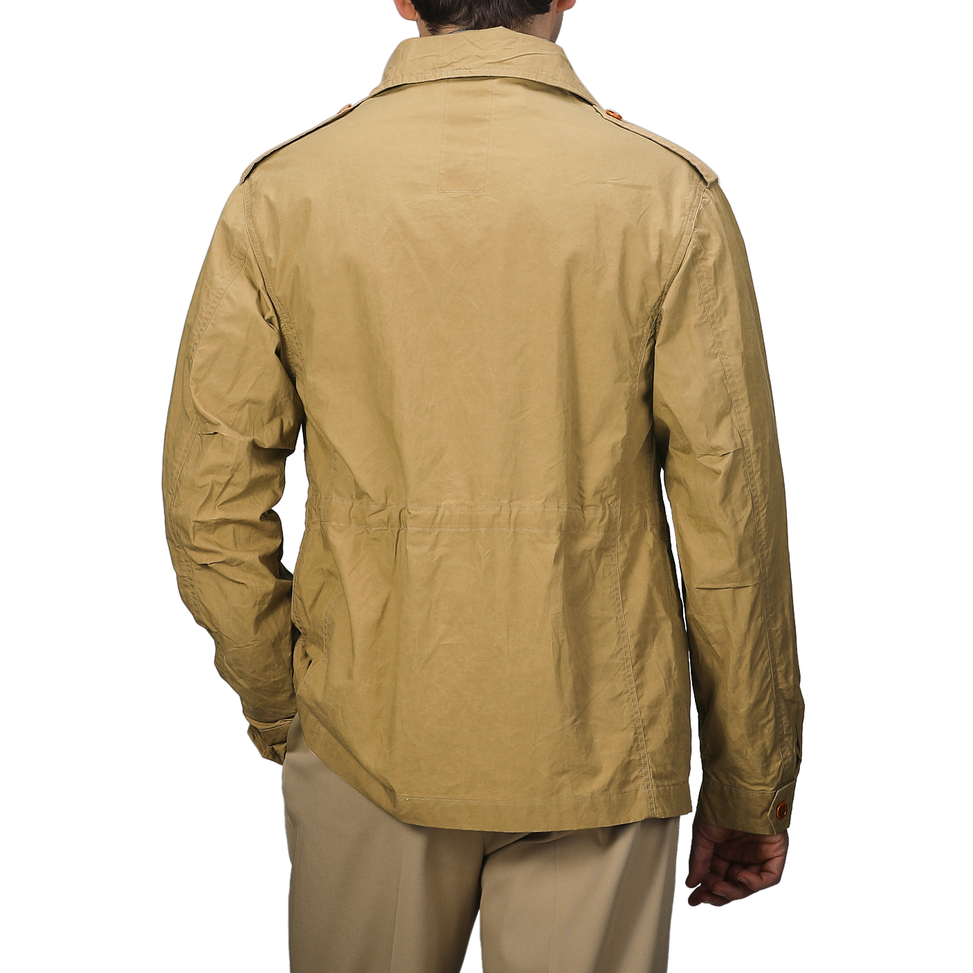 A person in a Khaki Beige Waxed Cotton Smith SFO Jacket by L'Impermeabile, highlighting exquisite Italian craftsmanship, stands with their back to the camera against a gray background.