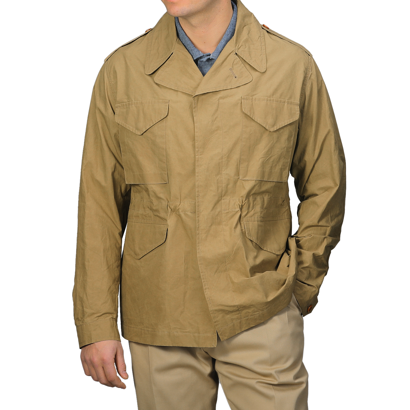 Someone wearing a Khaki Beige Waxed Cotton Smith SFO Jacket by L'Impermeabile, known for Italian craftsmanship and multiple pockets, is paired with a light blue shirt and khaki pants.