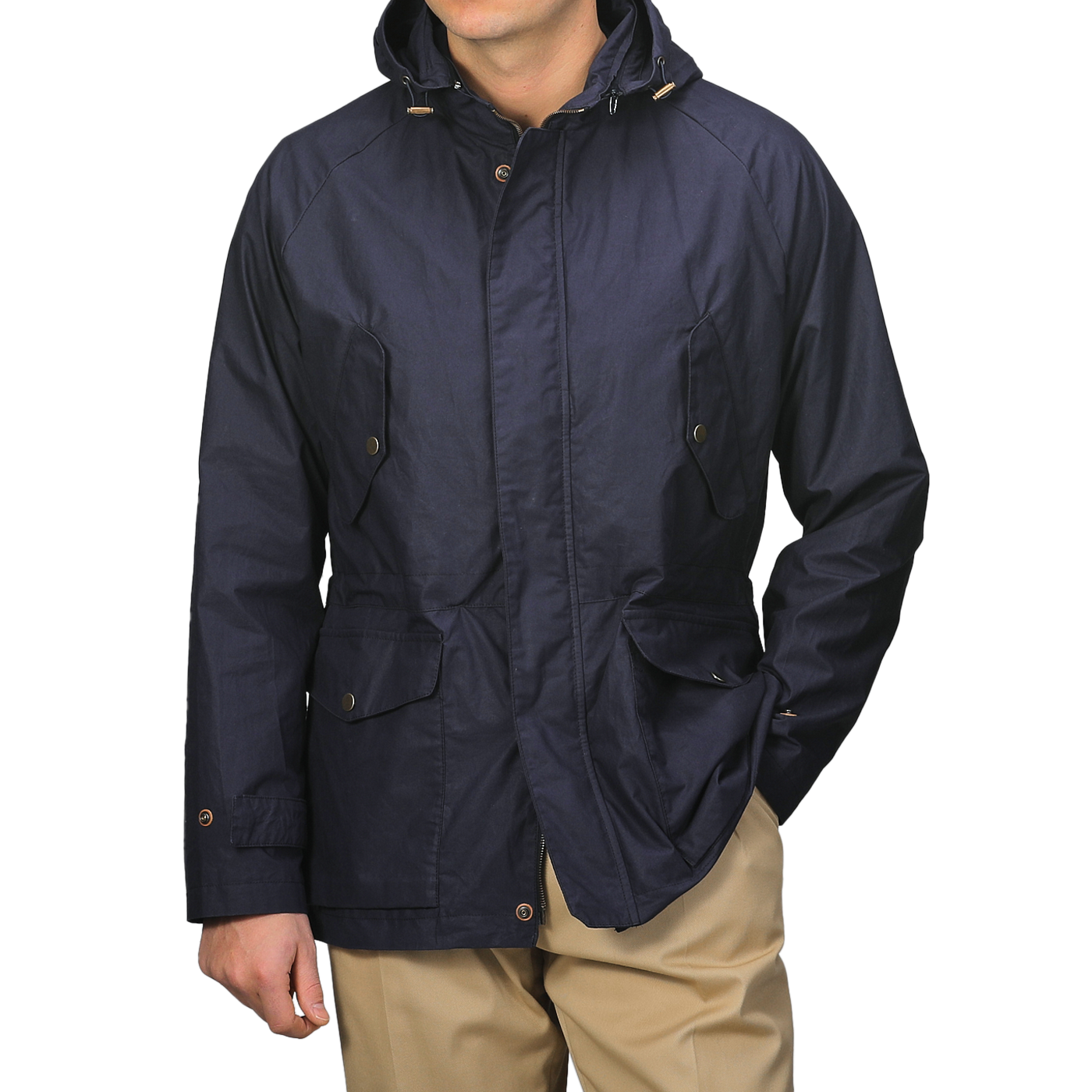 A person wearing L'Impermeabile's Navy Blue Waxed Cotton Bob Short Parka and beige pants keeps their face hidden with a water-repellant jacket featuring buttoned pockets and a front closure.