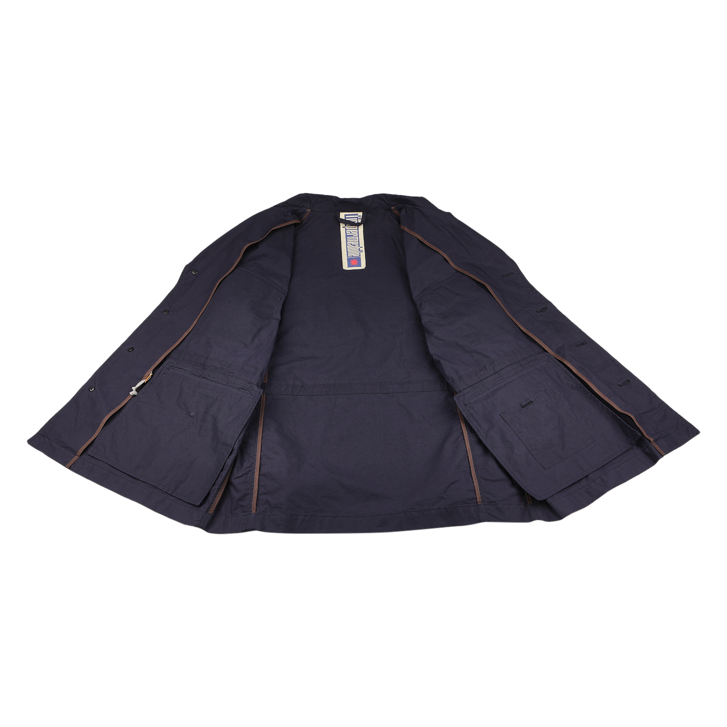 The L'Impermeabile Navy Blue Waxed Cotton Smith SFO Jacket rests open on a white surface, showcasing its interior lining and tags. This field jacket includes side pockets and offers water-repellent fabric for enhanced practicality.