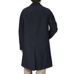 The back view of a man wearing a Navy Blue Waxed Cotton Kamikaze Trenchcoat from L'Impermeabile.