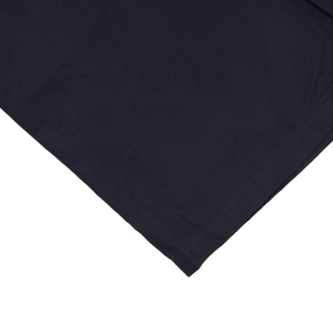 An image of a Navy Blue Waxed Cotton Kamikaze Trenchcoat pocket square by L'Impermeabile on a white surface.