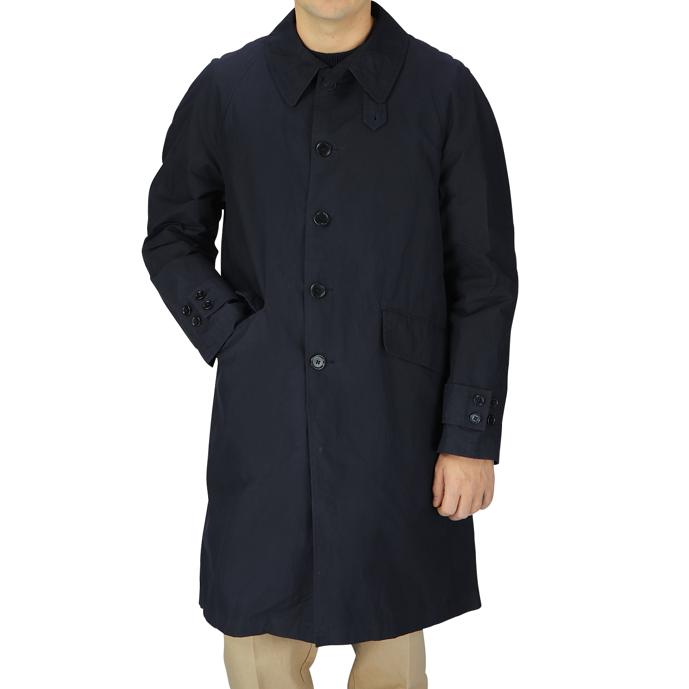 A young man wearing a Navy Blue Waxed Cotton Kamikaze trench coat from L'Impermeabile Italy.