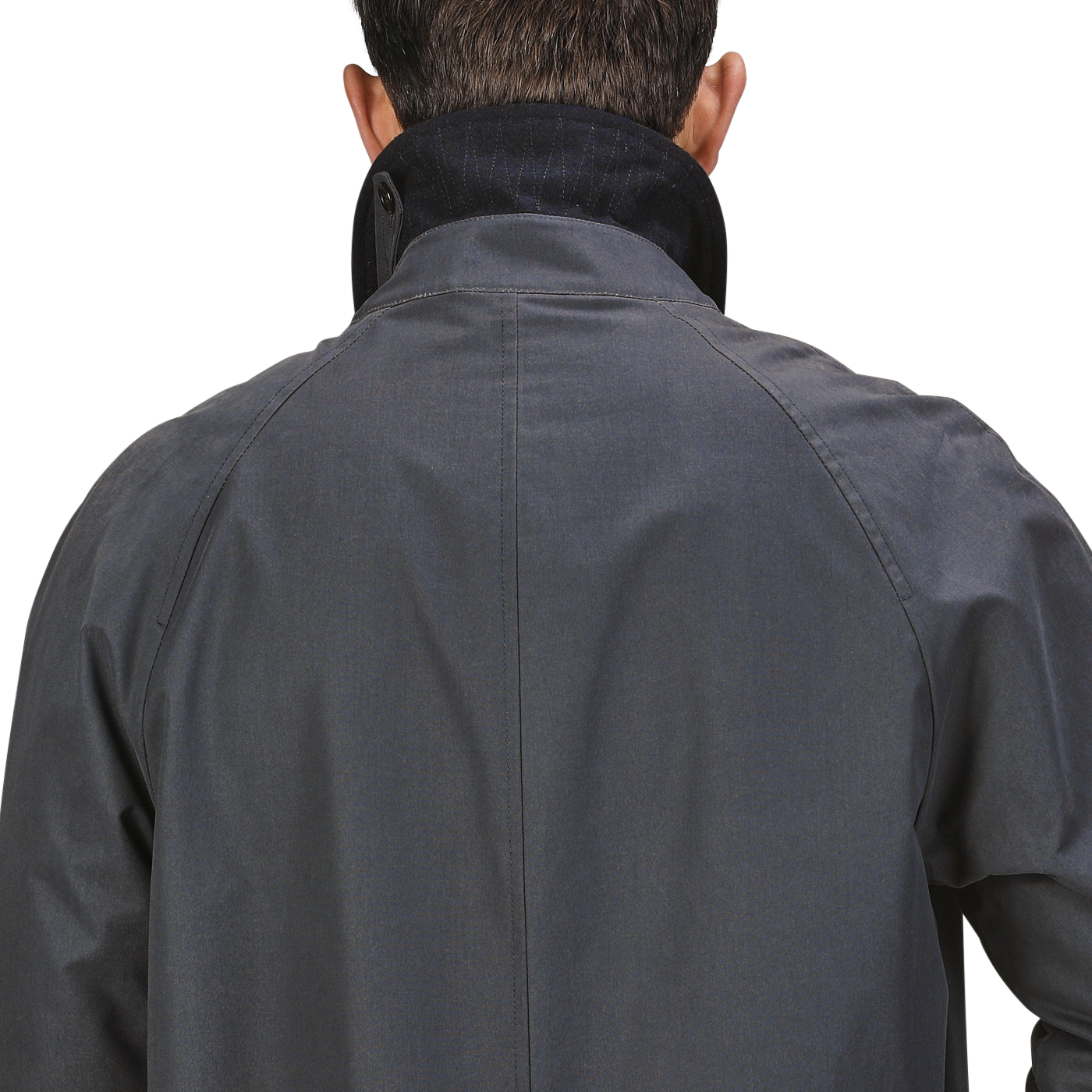 Back view of a person wearing a Washed Blue Waxed Cotton Kamikaze Coat from L'Impermeabile with the collar turned up.