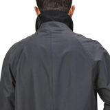 Back view of a person wearing a Washed Blue Waxed Cotton Kamikaze Coat from L'Impermeabile with the collar turned up.