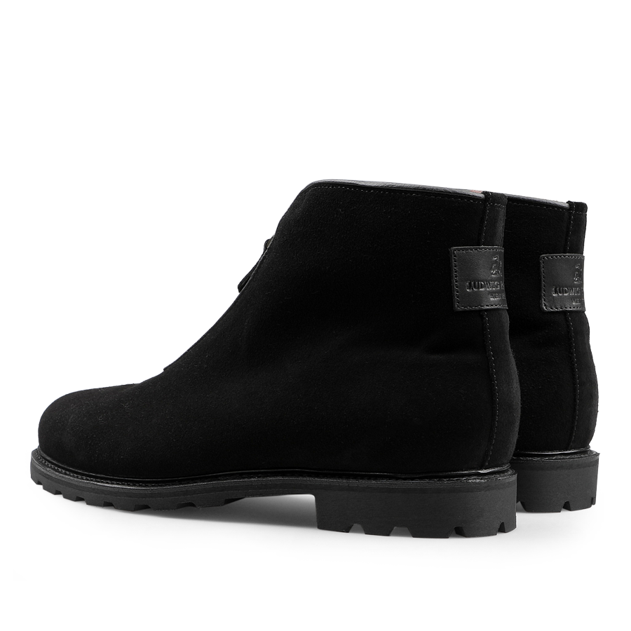 Black suede leather après ski boots by Ludwig Reiter with chunky Vibram rubber soles, side zippers, and a branded label on the heel.