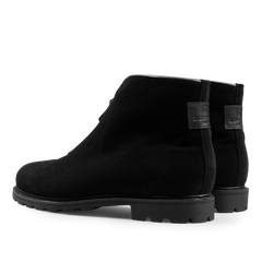 Black suede leather après ski boots by Ludwig Reiter with chunky Vibram rubber soles, side zippers, and a branded label on the heel.