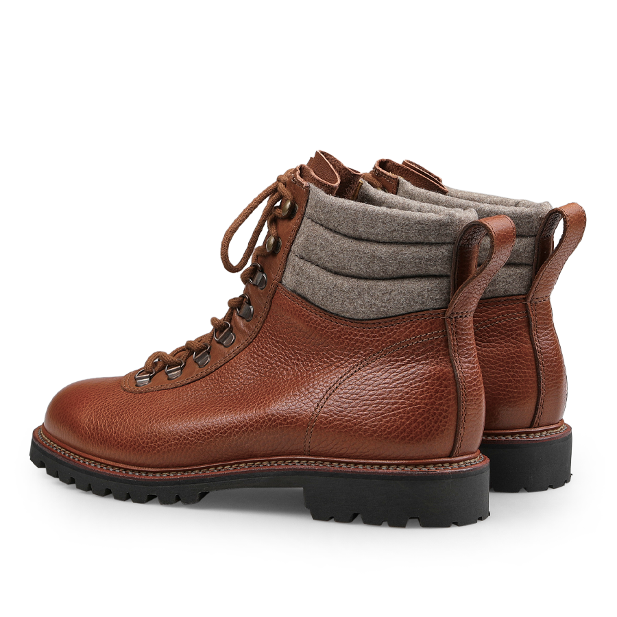 Mahogany Grain Leather Gebirgsjäger Boots by Ludwig Reiter feature brown grain leather with thick soles, gray padded fabric around the ankles, and a lace-up closure, crafted in sturdy country calf grain leather.