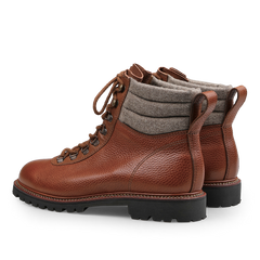 Mahogany Grain Leather Gebirgsjäger Boots by Ludwig Reiter feature brown grain leather with thick soles, gray padded fabric around the ankles, and a lace-up closure, crafted in sturdy country calf grain leather.