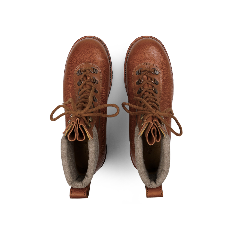 A pair of Mahogany Grain Leather Gebirgsjäger Boots by Ludwig Reiter, crafted with laces and metal eyelets from country calf grain leather, viewed from above. These boots showcase a textured exterior and soft inner lining, providing both ruggedness and comfort for your adventures.