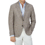A man wearing a Luigi Bianchi Italy-inspired tan and blue checked linen blazer.