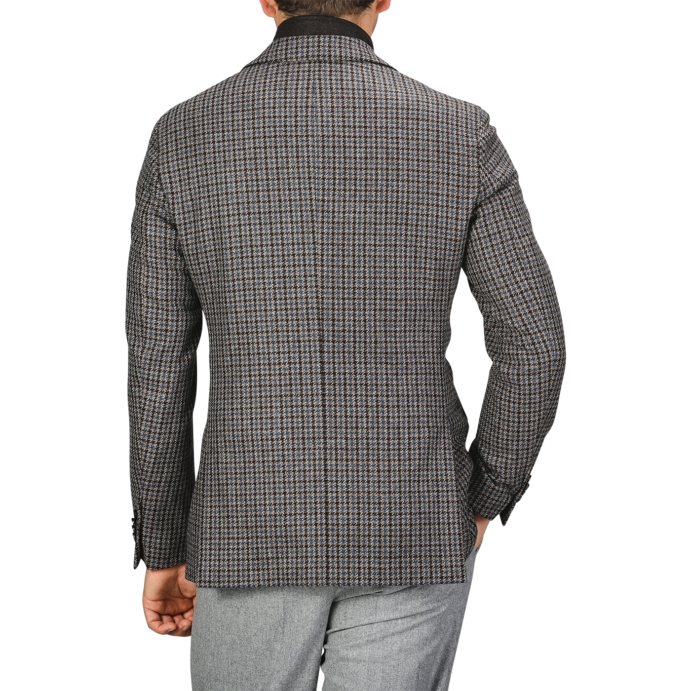 Back view of a person wearing a Luigi Bianchi Brown Houndstooth Wool Cashmere Hybrid Blazer and light grey pants, with their left hand partially visible.