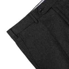 Close-up of the top section of a pair of charcoal grey trousers with a black button, visible belt loops, and a section of the waistband lining. These Luigi Bianchi Charcoal Grey Wool Flannel Flat Front Trousers exemplify sophistication and quality craftsmanship.