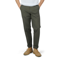 A man in Luigi Bianchi dark green cotton twill flat front trousers and a white t-shirt.