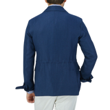 The back view of a man wearing a Luigi Bianchi Indigo Blue Linen Twill Field Jacket.