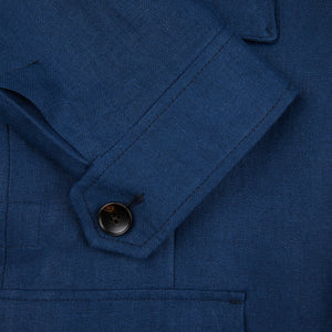 A close up of a Luigi Bianchi Indigo Blue Linen Twill Field Jacket with buttons.