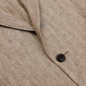 A close up of a Luigi Bianchi Light Brown Herringbone Linen Suit with expertise in tailoring.