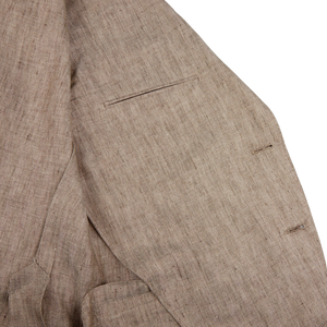 A close up of the Luigi Bianchi Light Brown Herringbone Linen Suit, showcasing expertise in tailoring.