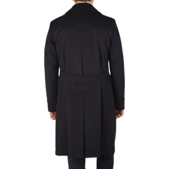 The back view of a man wearing a Luigi Bianchi navy blue wool cashmere dream polo coat.