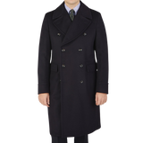 The man is wearing a Luigi Bianchi navy blue wool cashmere dream polo coat.