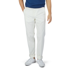 A man in a blue shirt and Luigi Bianchi Off-White Cotton Twill Flat Front Trousers.