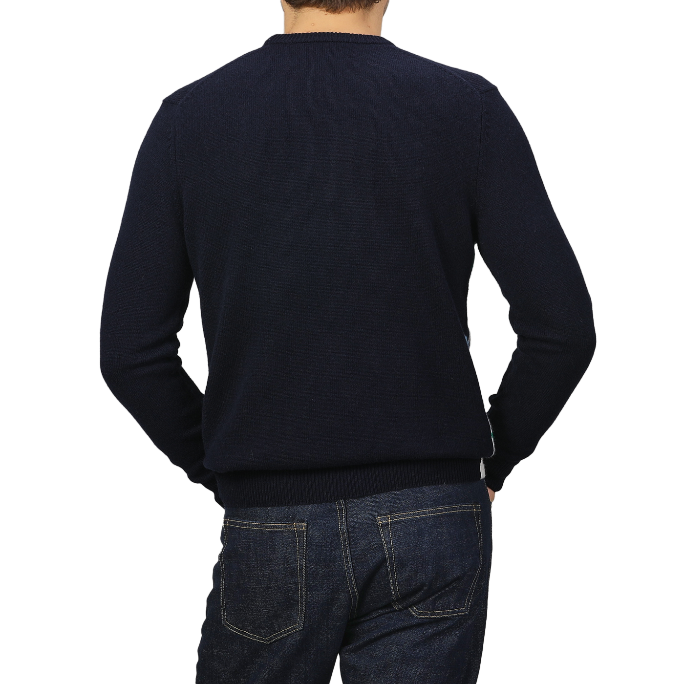 A person is wearing a Navy Blue Wool Cashmere Cortina Sweater from MC2 Saint Barth paired with jeans, capturing the cozy elegance of an Apres Ski Collection, seen from behind against a plain background.