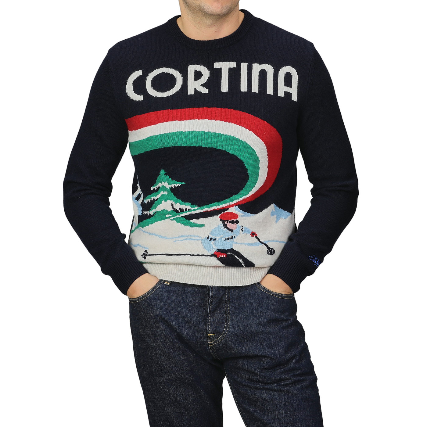 A person is wearing the Navy Blue Wool Cashmere Cortina Sweater from MC2 Saint Barth, featuring a skier and "Cortina" text design, with their hands in pockets while also wearing jeans.