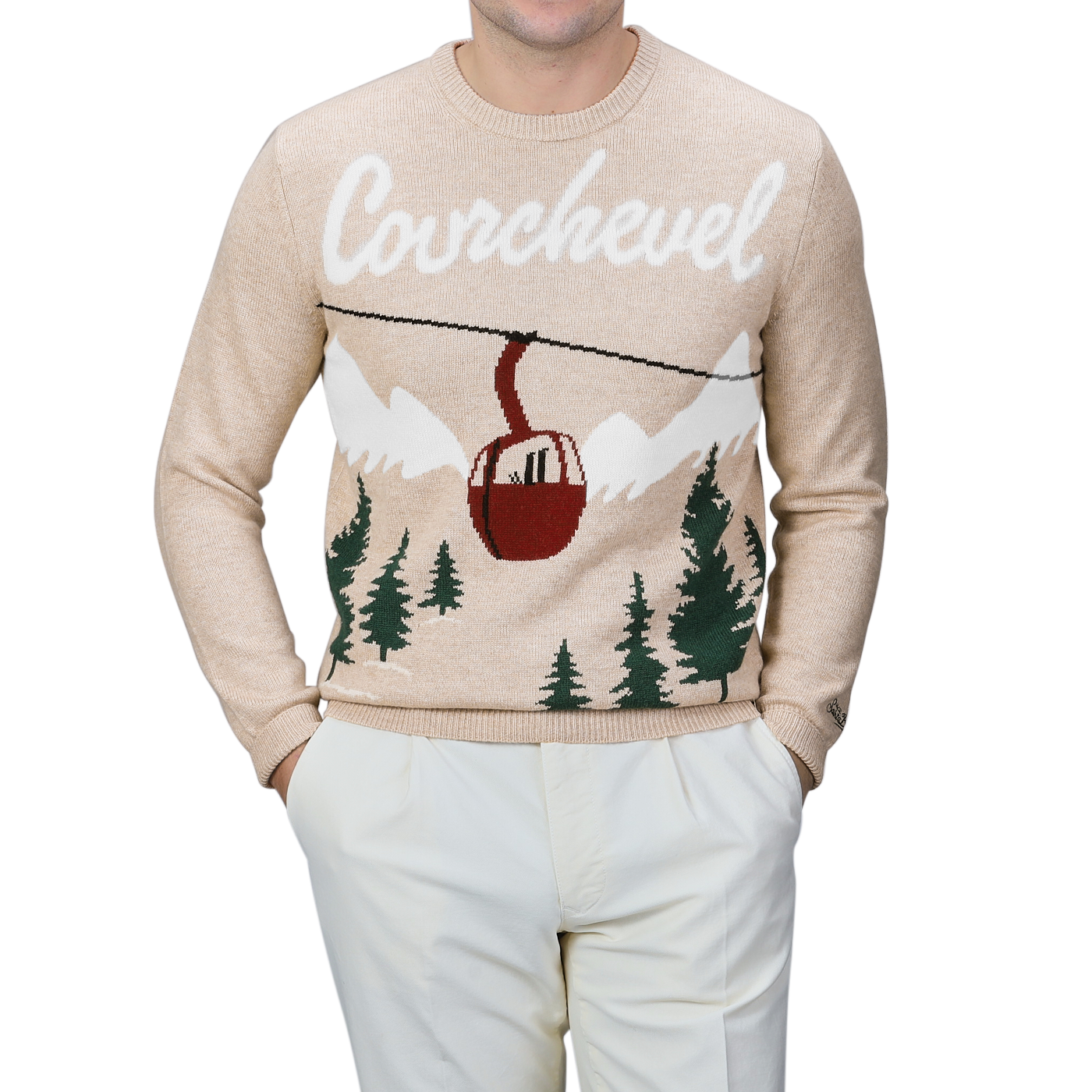 An individual is dressed in a beige sweater from MC2 Saint Barth, specifically the Beige Wool Cashmere Courchevel Sweater featuring "Courchevel" and a ski lift design, complemented by white pants.