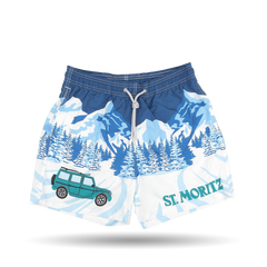 The Blue St. Moritz Printed Swim Shorts by MC2 Saint Barth showcase a mountain and forest design in blue and white, accented with a green SUV and "St. Moritz" printed on the right leg, making them ideal for your next adventure.