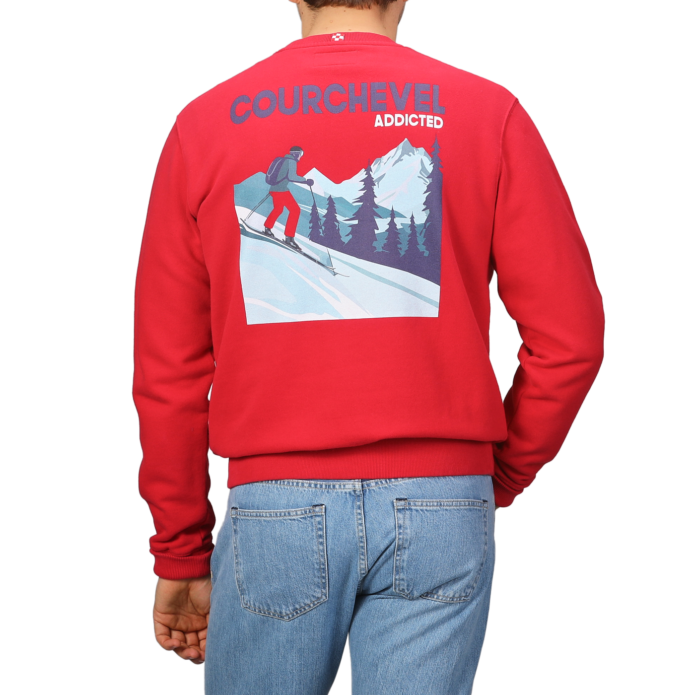 A person is sporting the Bright Red Cotton Courchevel Sweater by MC2 Saint Barth, featuring a skiing graphic and "COURCHEVEL ADDICTED" text on the back, embodying the perfect après-ski vibe, paired with blue jeans.