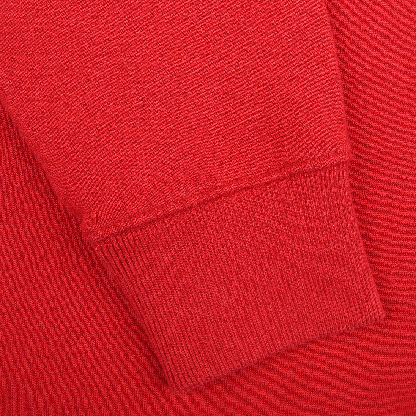 A close-up of the MC2 Saint Barth Bright Red Cotton Courchevel Sweater sleeve, featuring a ribbed cuff against a solid red backdrop, captures the cozy elegance of après-ski style in Courchevel.