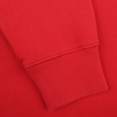 A close-up of the MC2 Saint Barth Bright Red Cotton Courchevel Sweater sleeve, featuring a ribbed cuff against a solid red backdrop, captures the cozy elegance of après-ski style in Courchevel.