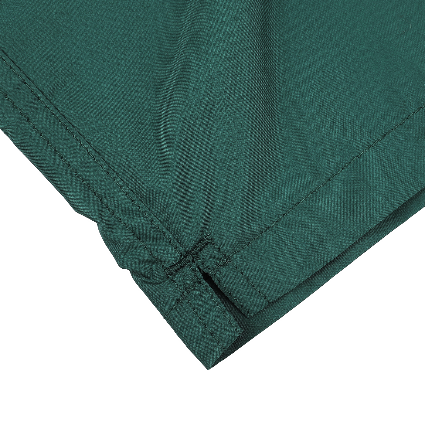 Close-up of the corner of a British green fabric with visible stitching and a soft texture, reminiscent of MC2 Saint Barth's British Green Pantone 18-5315 Swim Shorts.