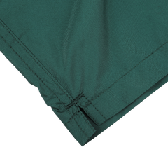 Close-up of the corner of a British green fabric with visible stitching and a soft texture, reminiscent of MC2 Saint Barth's British Green Pantone 18-5315 Swim Shorts.