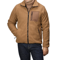 A person wearing an MC2 Saint Barth Camel Beige Sherpa Fleece Jacket with houndstooth details and blue jeans.