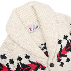 Detailed view of the MC2 Saint Barth Cream White Wool Nordic Aztec Cardigan, crafted from a soft wool-blend. This cream knitted sweater displays black and red geometric patterns, with a unique shawl collar and a single black button.