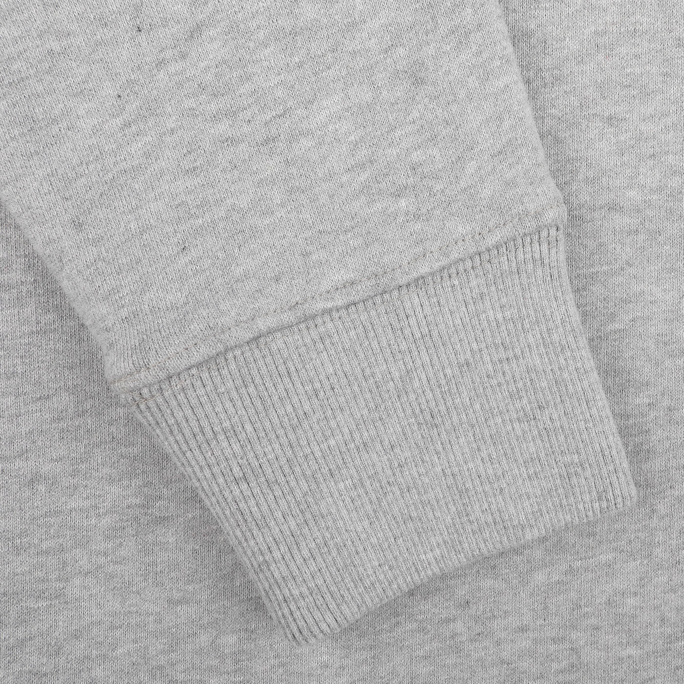 Close-up of the sleeve of the Grey Melange Cotton Aspen Sweater by MC2 Saint Barth, featuring a ribbed cuff that's ideal for cozy Aprés Ski evenings. The image showcases the fabric texture and stitching details, evoking memories of relaxed nights at Aspen ski resorts.