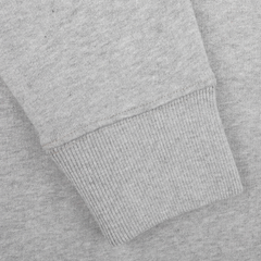 Close-up of the sleeve of the Grey Melange Cotton Aspen Sweater by MC2 Saint Barth, featuring a ribbed cuff that's ideal for cozy Aprés Ski evenings. The image showcases the fabric texture and stitching details, evoking memories of relaxed nights at Aspen ski resorts.