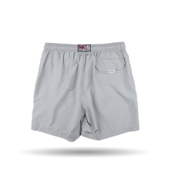 Introducing the Light Grey Pantone 15-4307 Swim Shorts by MC2 Saint Barth, featuring an elastic waistband, button closure, and a back pocket with a stylish tag above it. Crafted from quick-drying fabric, this piece is a testament to the Pantone collaboration that seamlessly blends function and style.