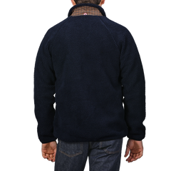 Rear view of a person in a regular fit, Navy Blue Sherpa Fleece Jacket by MC2 Saint Barth layered over a collared shirt, paired with dark jeans.