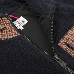 Close-up of the MC2 Saint Barth Navy Blue Sherpa Fleece Jacket featuring camel beige houndstooth pockets, zipped halfway open to show the interior tag labeled "It's a Beach Ski Collection M." The regular fit design offers both comfort and style for any occasion.