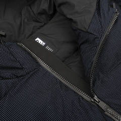 This close-up highlights the Navy Blue Technical Padded Maier Jacket from MC2 Saint Barth, featuring black and blue stripes, a visible zipper, and an internal clothing label. With its recycled filling, it captures the timeless style of Saint Barth.