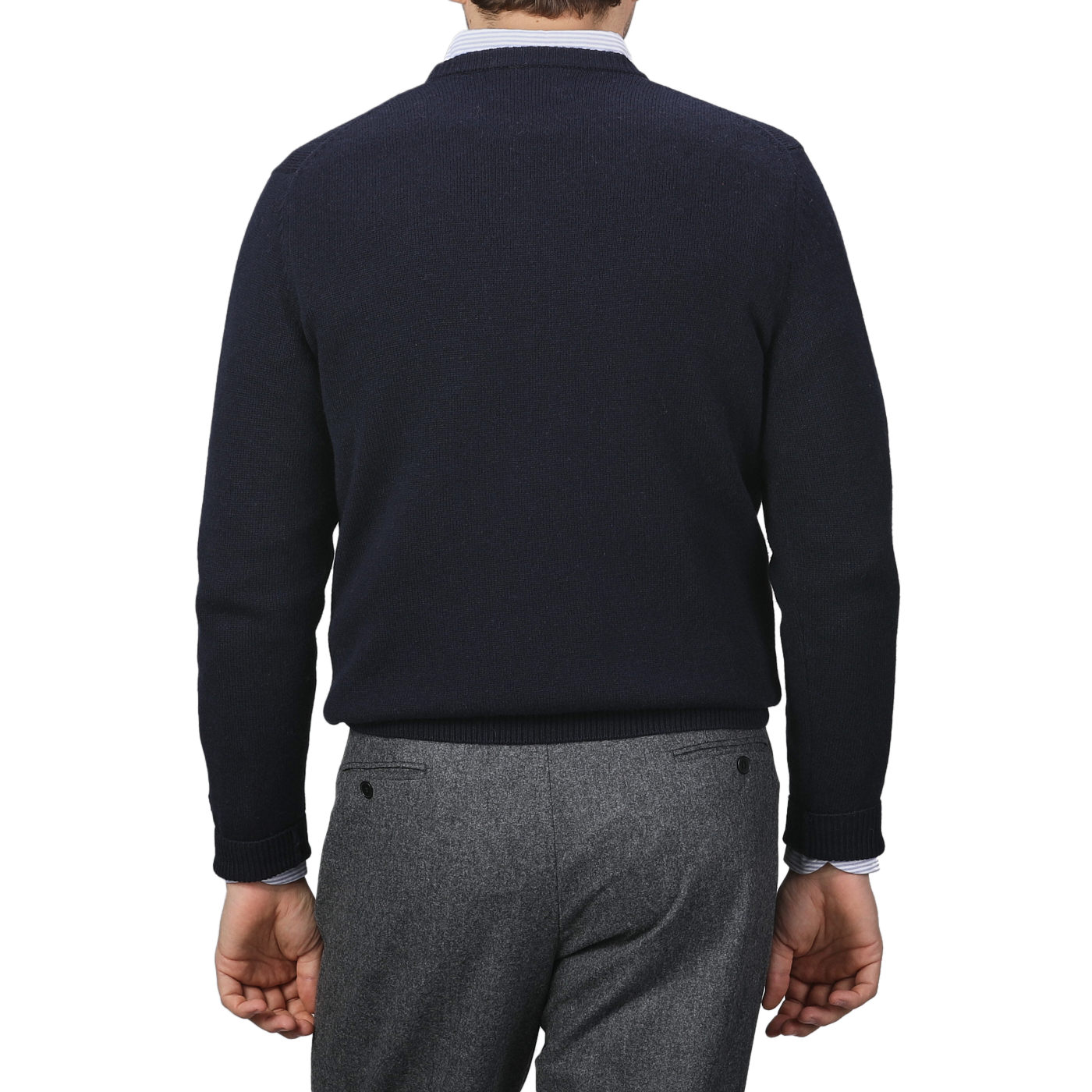 A person wearing an MC2 Saint Barth Navy Blue Wool Cashmere Aprés Ski Sweater and gray trousers is shown from the back, capturing the cozy elegance of the Après Ski Collection.