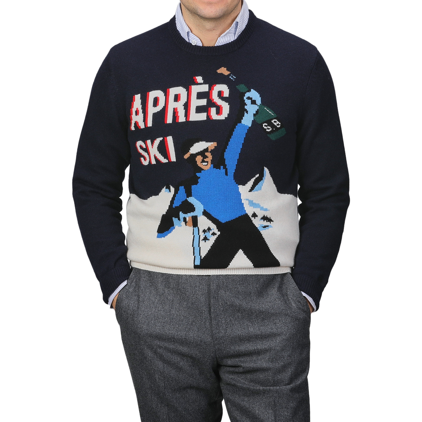 A person wearing the MC2 Saint Barth Navy Blue Wool Cashmere Aprés Ski Sweater, adorned with a graphic of a skier holding a bottle and majestic ski resorts in the background.