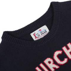 A close-up of the Navy Blue Wool Cashmere Courchevel Sweater from MC2 Saint Barth features red and white text on the front. The collar showcases the "St. Barth" label, infusing your winter wardrobe with a hint of Courchevel chic.