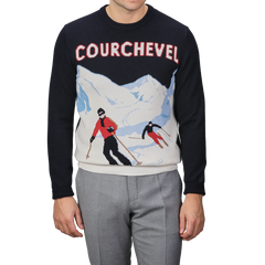 Someone is seen wearing the Navy Blue Wool Cashmere Courchevel Sweater from MC2 Saint Barth, showcasing a vibrant skiing scene and prominently featuring "Courchevel," in honor of one of the most famous ski resorts.